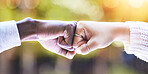 Fist bump, diversity and hands of people in park for support, agreement and collaboration in nature. Friends, greeting and closeup of hand gesture for friendship, community and solidarity outdoors