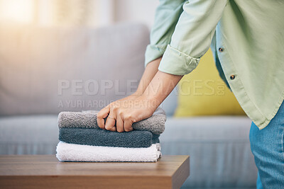 Buy stock photo Hands, home and laundry on living room table for hygiene, cleaning and folding for housework in morning. Woman, fabric and cotton towel on desk for organized house, service and routine in apartment