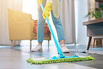 Woman, hands and cleaning floor with mop in living room for hygiene, bacteria or germ removal at home. Female person, housekeeper or maid in domestic service, dirt or dust for disinfection in house