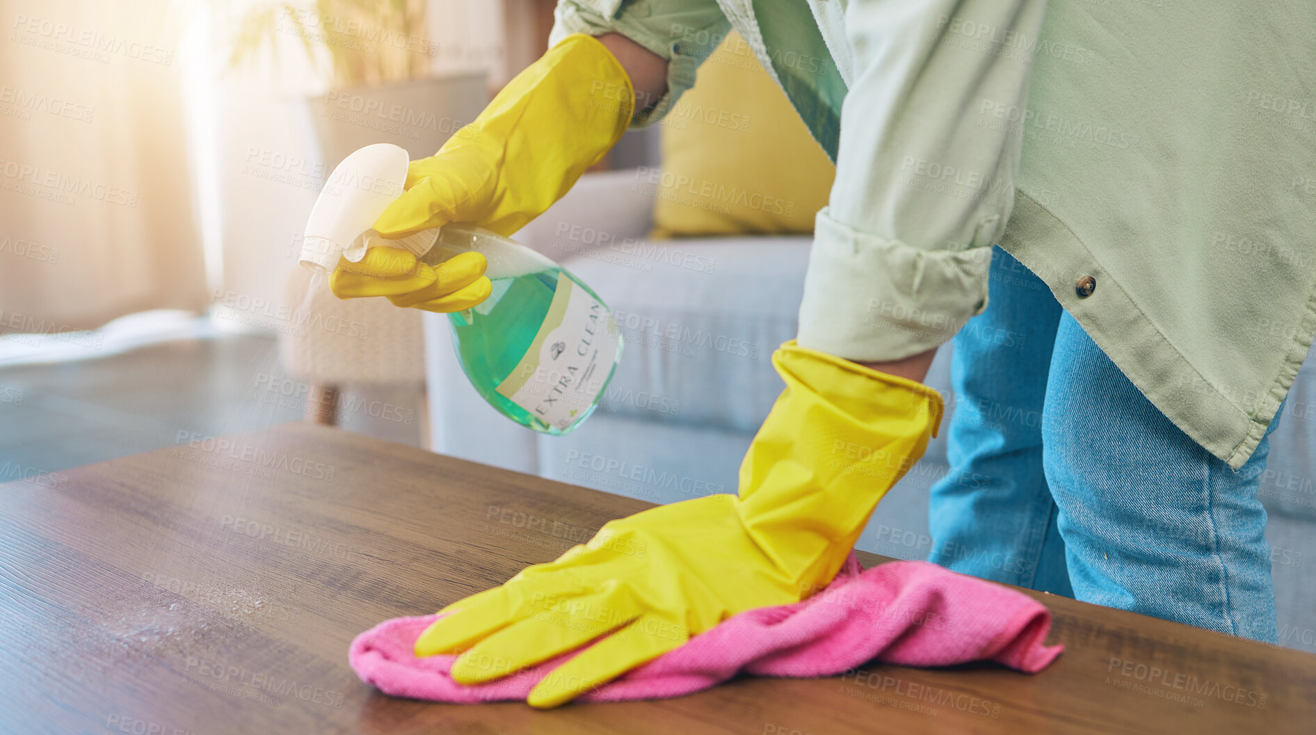 Buy stock photo Woman, hands and cleaning table with spray for housekeeping, hygiene or bacteria removal at home. Female person or cleaner spraying chemical bottle for germs, dirt and wiping wooden desk or furniture