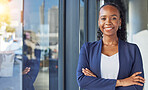 Portrait, window and arms crossed with a business black woman standing in her professional office. Smile, corporate leadership with a happy female manager or boss in the workplace for empowerment