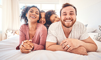 Buy stock photo Portrait, happy family and relax on a bed, bond and having fun on the weekend in their home together. Interracial, love and face of playful children with parents in a bedroom, smile and playing games