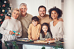 Christmas, portrait and family cooking cookies in home kitchen, bond and together. Xmas, baking food and happy face of grandparents, children and interracial parents at party, celebration or holiday