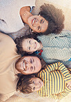 Portrait, happy family and top view on carpet in home for bonding together. Face, smile and parents with children on floor, interracial mother and father with kids, love and care for quality time