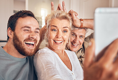 Buy stock photo Man, senior parents and selfie in home, funny and peace sign for horns, bunny ears and laugh for post on web. Family house, people and memory with profile picture, photography and social network app