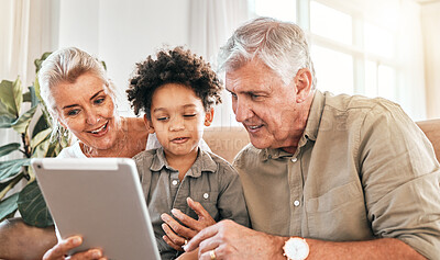 Buy stock photo Family, grandparents and child on tablet in home e learning, online education and watch or streaming cartoon. Happy interracial kid and senior people on digital technology for teaching school on sofa
