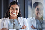 Business woman, smile and happy portrait in an office with arms crossed and career pride. Face of a young female entrepreneur with confidence, positive mindset and commitment to corporate startup