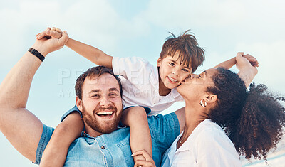 Buy stock photo Beach, father and a mother kiss child on the cheek while on a vacation, holiday or adventure. A woman, man and kid on shoulders for a portrait outdoor of summer fun and travel with multiracial family