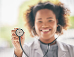 Healthcare, stethoscope and cardiology with a doctor in the hospital for a routine checkup during an appointment. Medical, hand and heart health with a woman medicine professional in a clinic