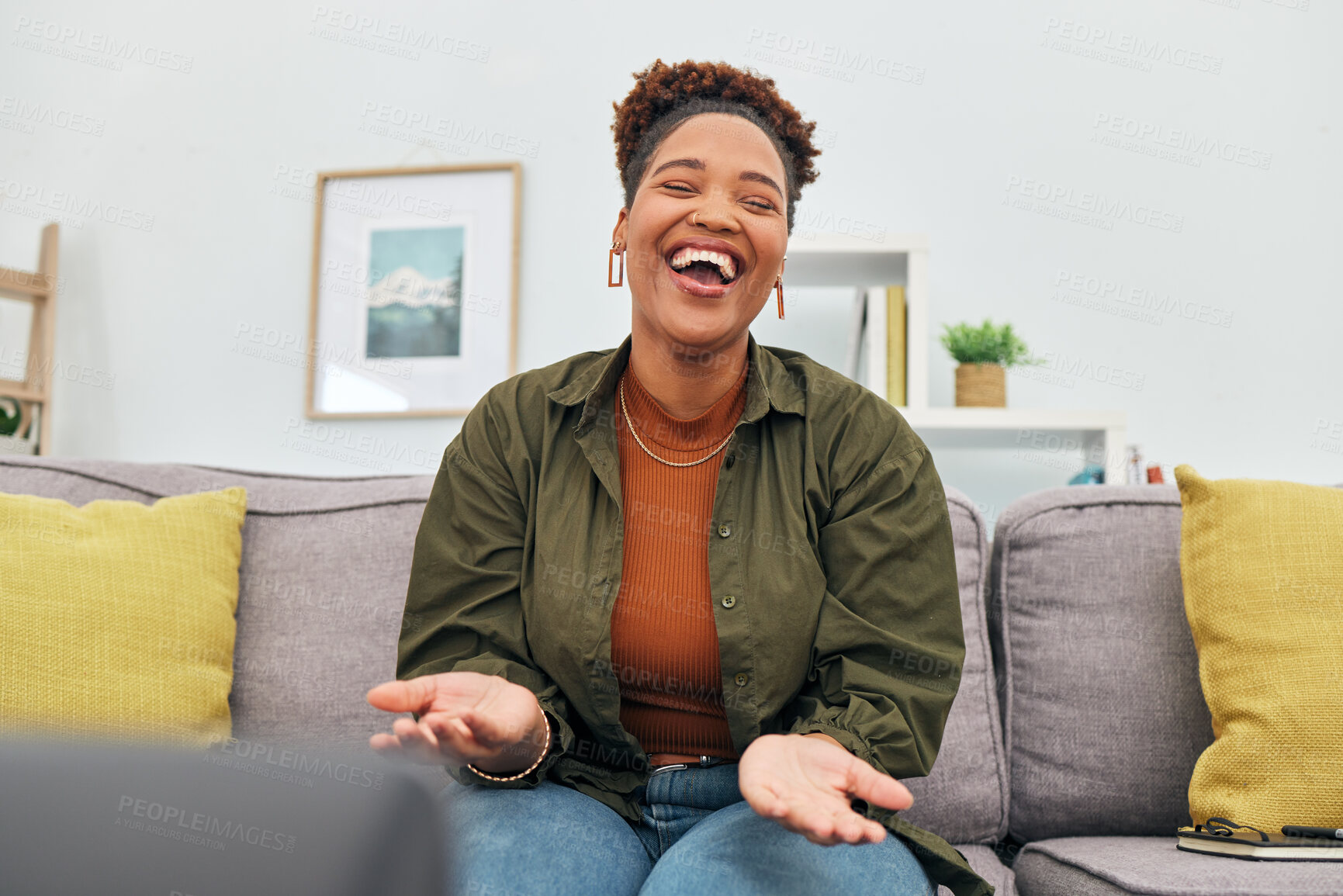 Buy stock photo Comic, happy or funny with a black woman laughing while sitting on a sofa in the living room of her home. Comedy, smile and freedom with a carefree young female person joking eyes closed in her house