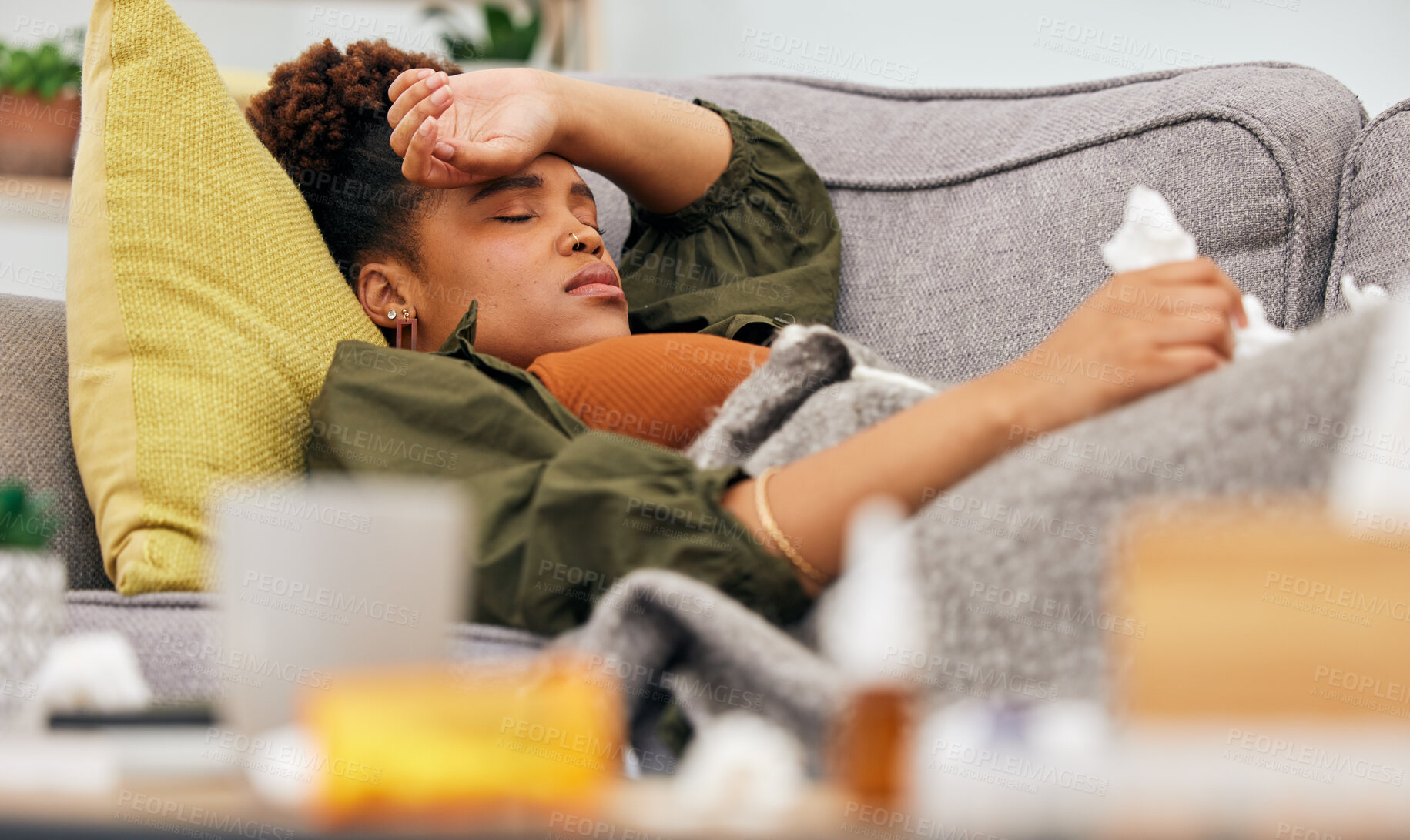 Buy stock photo Sick, pills and black woman on sofa with tissue paper, flu and headache from viral infection in her home. Bacteria, migraine and African lady with virus, fatigue and nausea medicine in living room