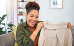 Fashion, influencer and a black woman streamer unboxing a clothes outfit in her home. Social media, brand deal and a happy female content creator recording a live broadcast for subscription service
