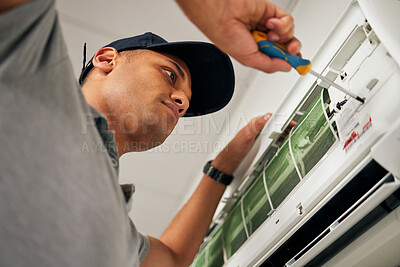 Buy stock photo Maintenance, air conditioner and man with screwdriver for problem solving on machine from below. Aircon, ac repair and handyman service with technician, electrician or contractor work on ventilation