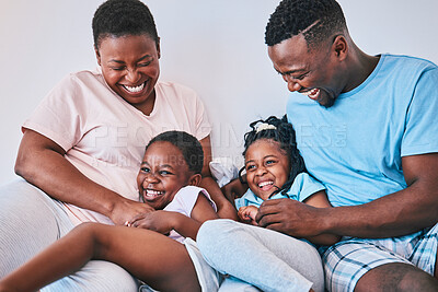 Buy stock photo Happy, black family and tickle in a bed with smile, care and laugh on the weekend in their home. Bond, playing and children with parents in bedroom with games and having fun in the morning together
