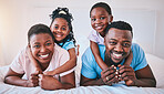 Happy, black family and portrait in a bed with smile, care and comfort on the weekend in their home. Face, smile and children with parents in bedroom playing, hug and relax while having fun together