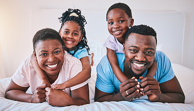 Buy stock photo Happy, black family and portrait in a bed with smile, care and comfort on the weekend in their home. Face, love and children with parents in bedroom playing, hug and relax in the morning together