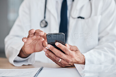 Buy stock photo Smartphone, hands and doctor typing at table in hospital for research, telehealth or healthcare. Phone, medical professional or surgeon, expert or person on wellness app, email or online consultation