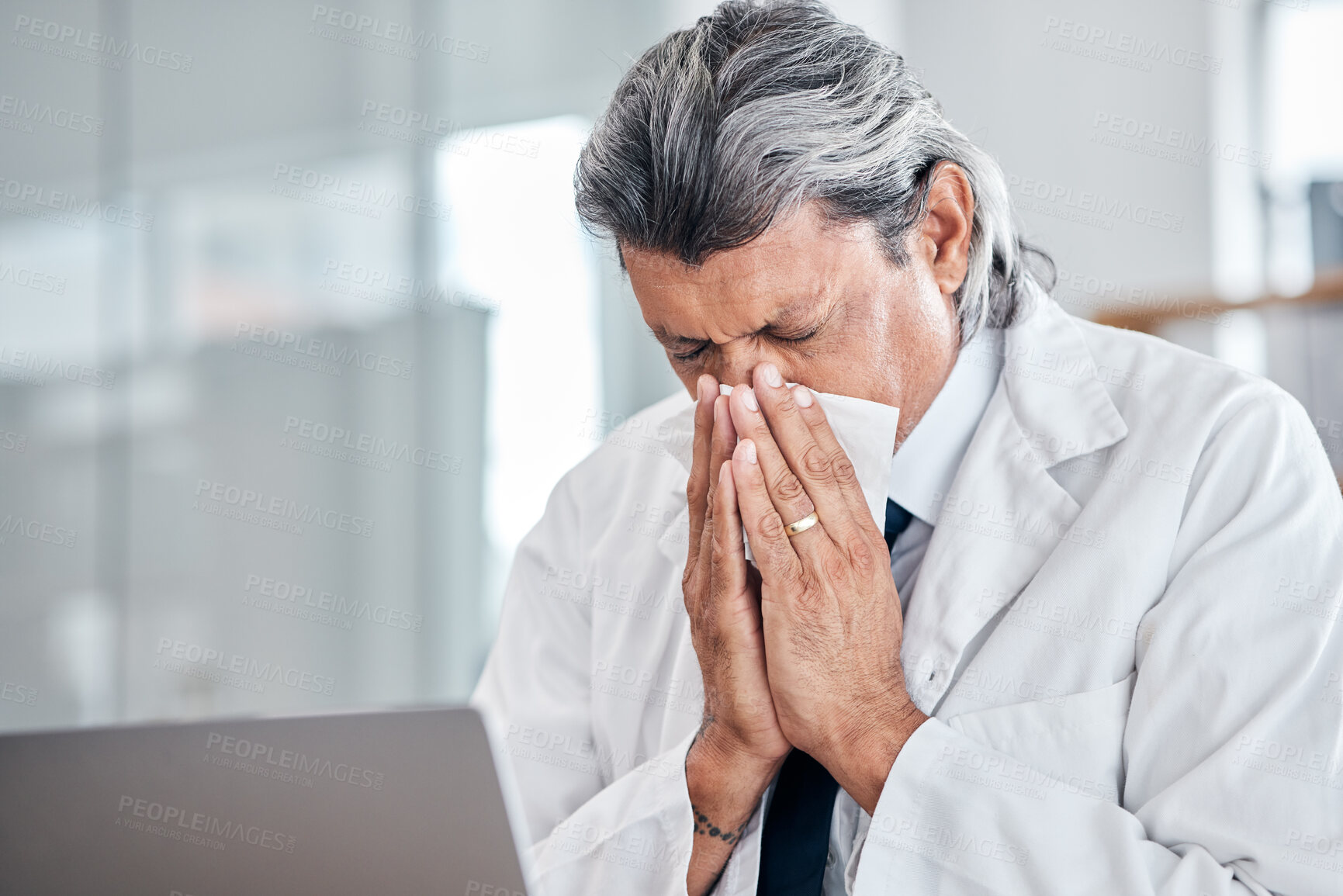 Buy stock photo Man, blowing nose and senior doctor sick with allergy, covid or virus in hospital or clinic. Elderly medical professional, tissue and allergies for health problem, cold fever and bacteria in winter