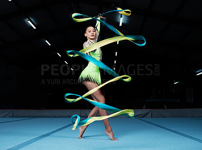 Buy stock photo Rhythmic gymnastics, woman in gym and ribbon, creativity and action with performance and fitness. Competition, athlete and female gymnast, dance and art with body, routine and energy at arena