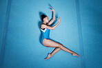 Above, dance and a woman for gymnastics on the floor, training and doing a professional routine. Creative, art and a young girl or athlete gymnast dancing for a competition, doing ballet or talent