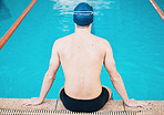Swimming, sports and man in pool for training, competition and exercise in water. Professional swimmer, fitness and back of male person practice for challenge, workout and performance for wellness