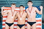 Winner, gold medal and the usa water polo team in celebration of success during a sports event in a gym. Fitness, victory and flag with happy male athletes cheering together in triumph on a podium