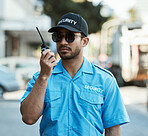 Walkie talkie, man and a security guard or safety officer outdoor on a city road with communication. Serious male person with radio on urban street to report crime for investigation and surveillance