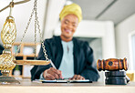 Legal, scale and black woman judge writing for an investigation document or criminal case in a law firm. Court, administration and lawyer working on justice or planning policy in an attorney office 