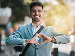 Hands in heart, business and portrait of man in city for support, startup goals and kindness in street. Travel, professional job and face of male worker with love emoji for career, working and job
