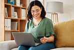 Online shopping, laptop and credit card, woman on sofa in living room for internet banking app in home with tech. Ecommerce payment, smile and cashback, girl at computer browsing retail website sale.