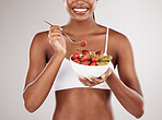 Woman, hands and diet with fruit salad for natural nutrition against a white studio background. Closeup of female person holding bowl of organic strawberry and kiwi to lose weight or healthy wellness