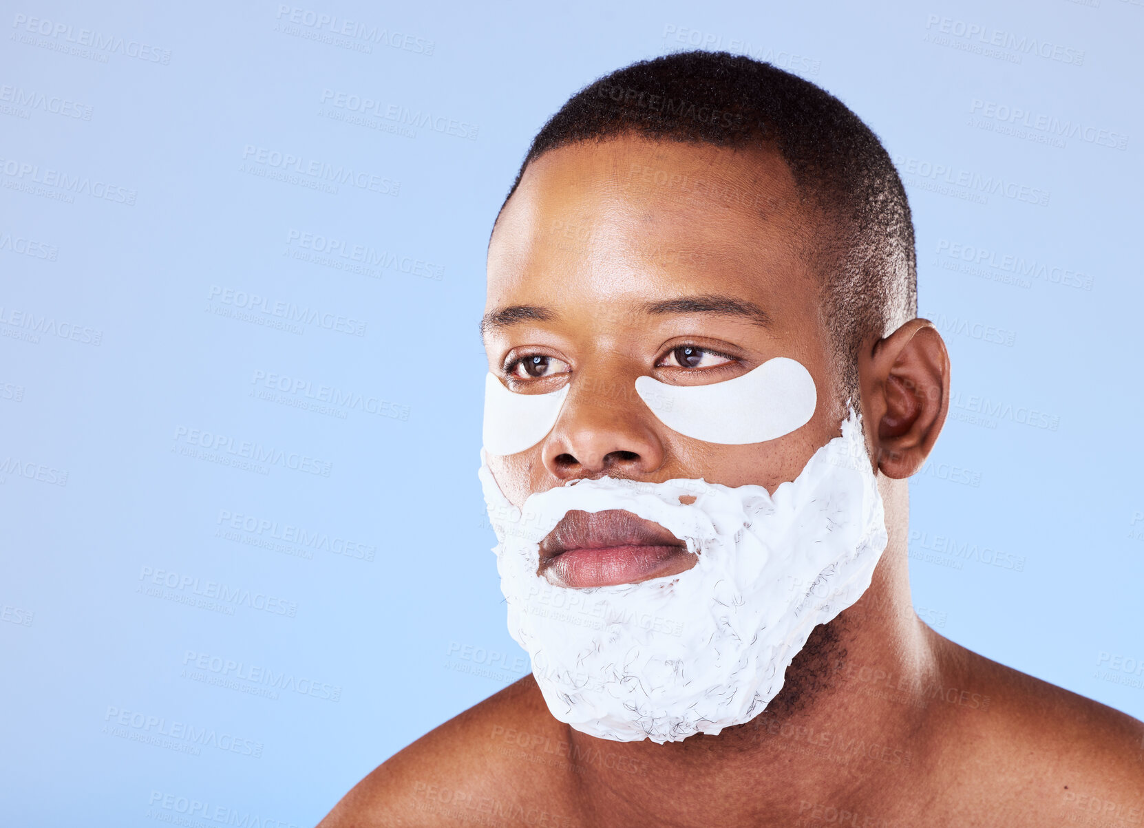 Buy stock photo Skincare, black man and eye mask while shaving in studio cleaning, cosmetic or treatment on blue background. Face, beauty and African guy model with gel patch and skin for facial, hair or wellness