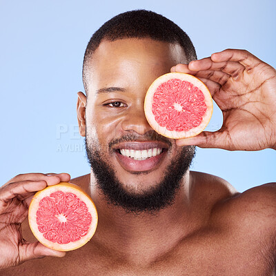 Buy stock photo Black man, grapefruit and studio portrait for skincare, detox or vitamin c for smile, health or wellness by background. African guy, model and citrus fruit in hands by eye, facial beauty or nutrition