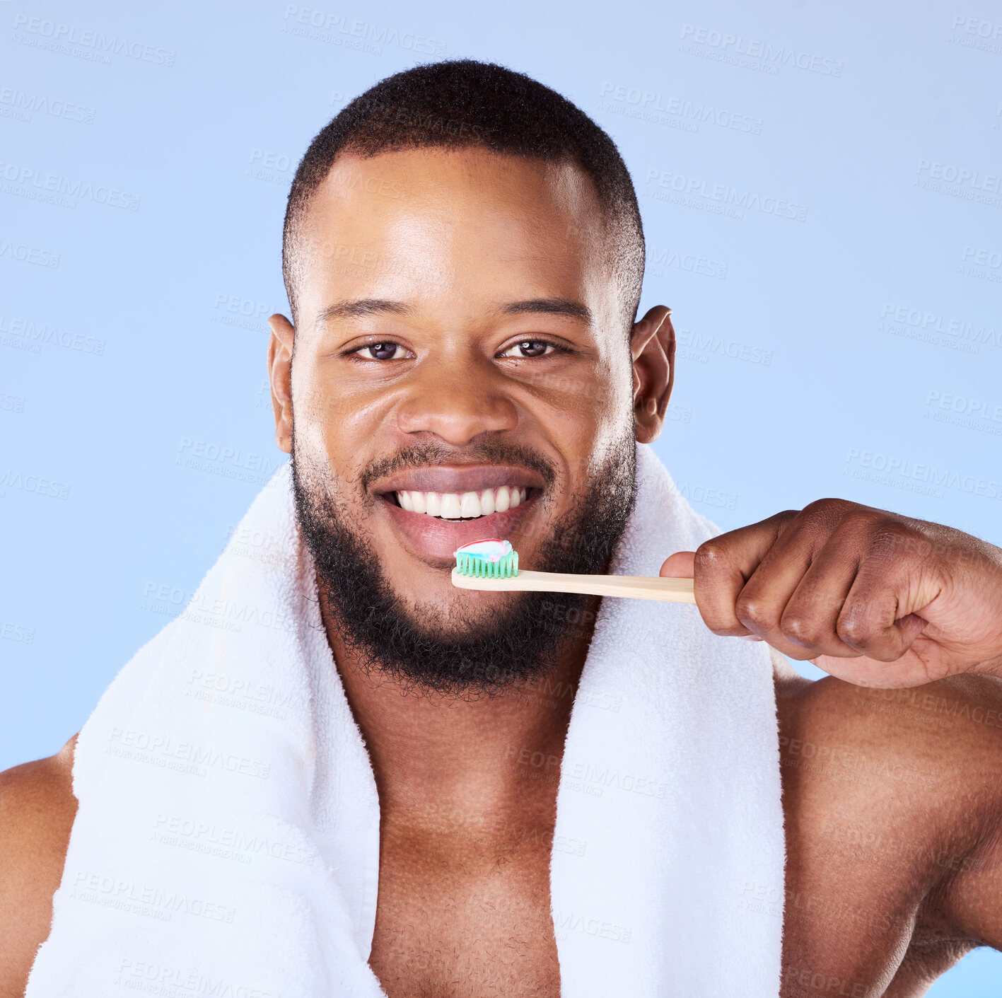 Buy stock photo Portrait, black man and brushing teeth in studio for dental, bamboo toothbrush and blue background. Face of male model cleaning mouth with eco friendly wooden product for fresh breath or oral hygiene