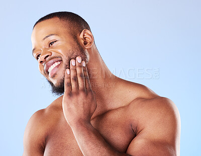 Buy stock photo Cosmetics, cleaning and black man with skincare, muscle and grooming against a blue studio background. Male person, model and guy with treatment, shine and glow with dermatology, aesthetic and health