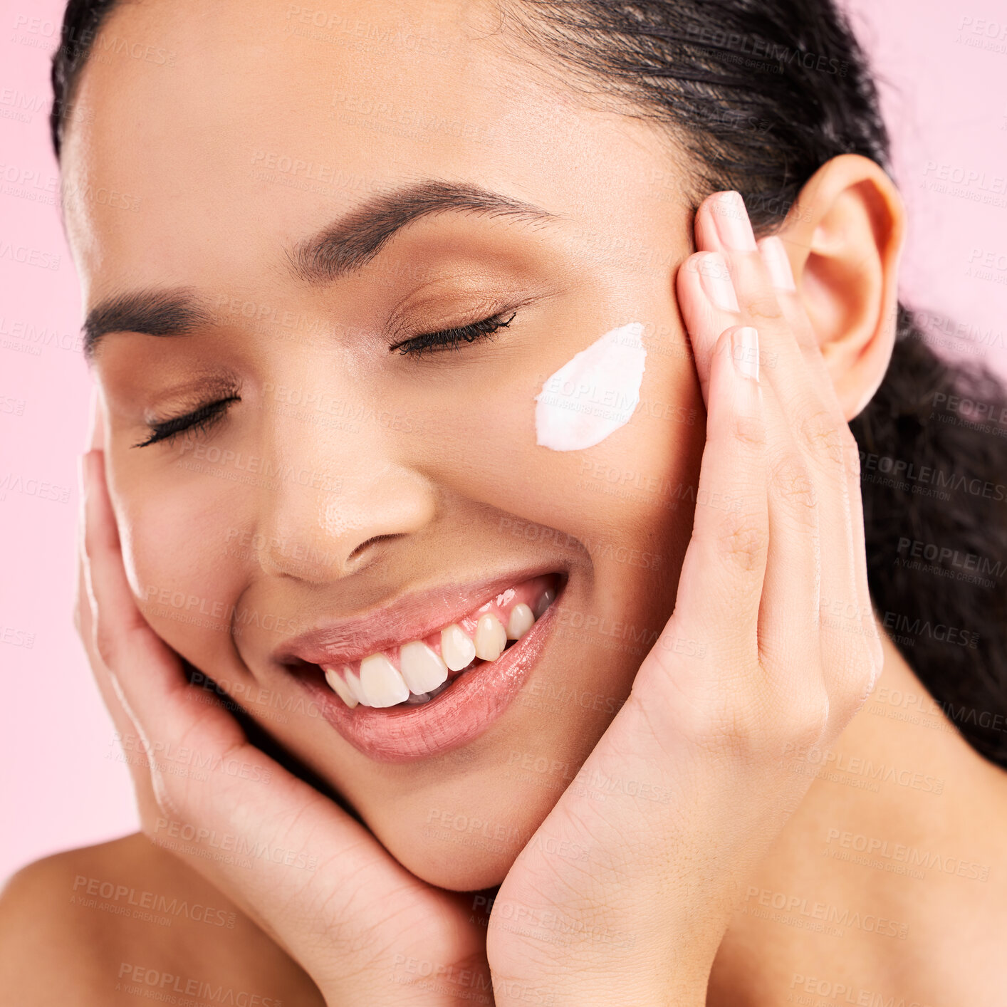 Buy stock photo Skincare, happy and woman with face cream in studio isolated on a pink background. Smile, beauty and natural model with moisturizer, cosmetic and apply dermatology product for wellness and health