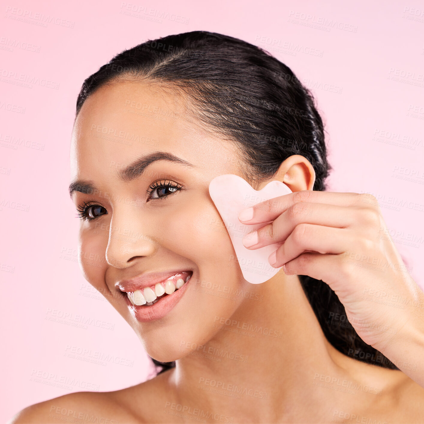 Buy stock photo Facial massage, natural beauty and woman with a gua sha, skin glow and cosmetics. Face of a young aesthetic female model happy with self care and dermatology stone results on a pink background