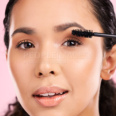 Buy stock photo Mascara, beauty and makeup on face of a woman in studio for eyelash cosmetics and natural glow. Portrait, application and skin care tools or product on a female aesthetic model on a pink background