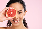 Face, skincare and happy woman with grapefruit in studio isolated on a pink background mockup space. Portrait, natural cosmetic or model with fruit, food or nutrition, healthy vegan diet or vitamin c