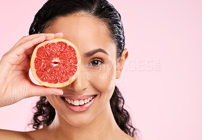 Buy stock photo Face, skincare and happy woman with grapefruit in studio isolated on a pink background mockup space. Portrait, natural cosmetic or model with fruit, food or nutrition, healthy vegan diet or vitamin c