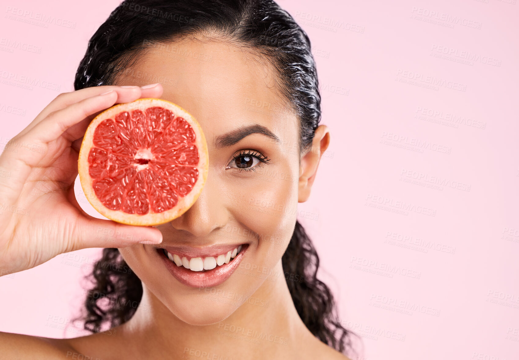 Buy stock photo Face, skincare and happy woman with grapefruit in studio isolated on a pink background mockup space. Portrait, natural cosmetic or model with fruit, food or nutrition, healthy vegan diet or vitamin c