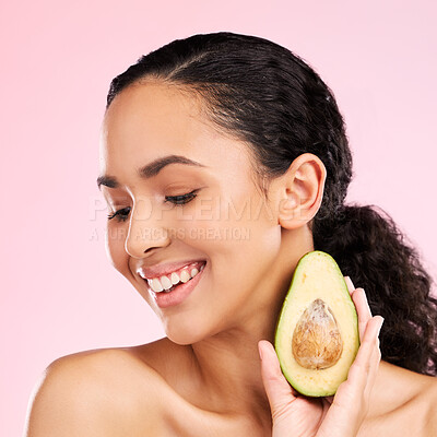 Buy stock photo Smile, skincare and woman with avocado in studio isolated on a pink background. Happy, natural cosmetic or model with fruit, food or nutrition for healthy diet, vegan or omega 3 benefits for wellness