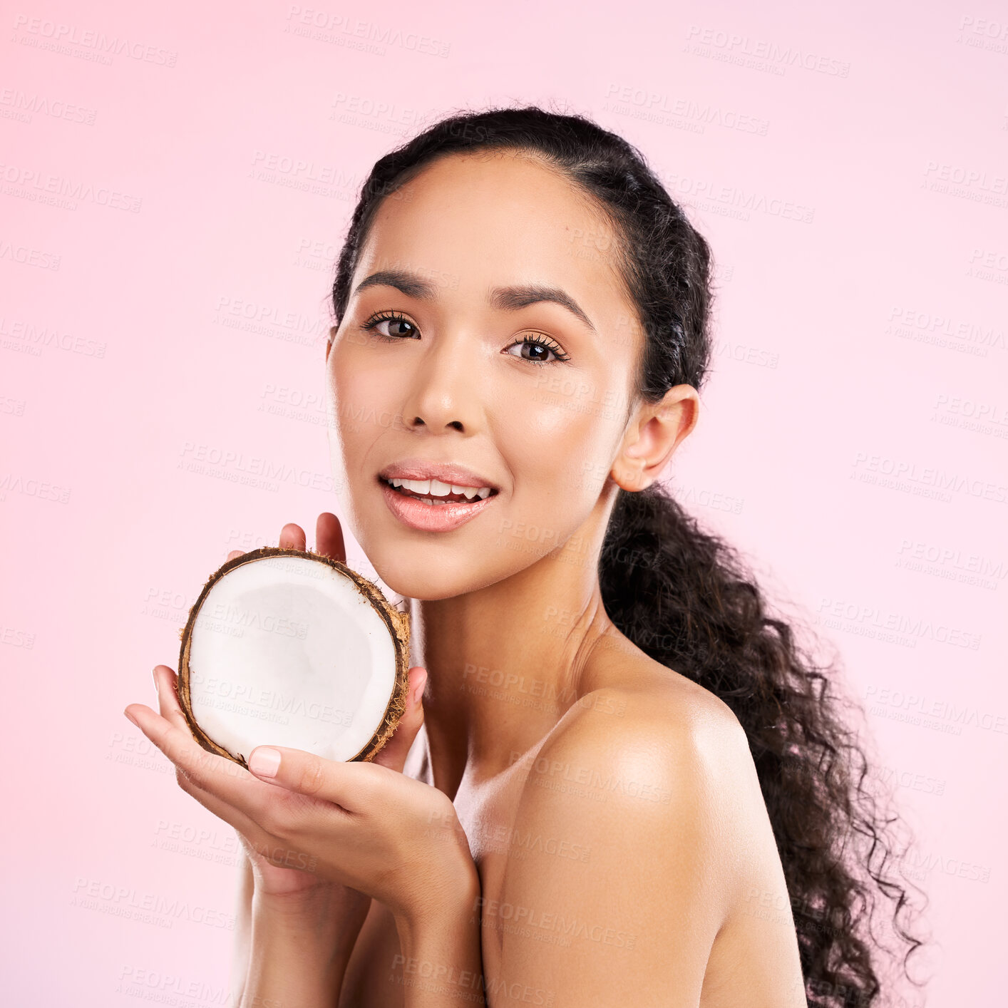 Buy stock photo Woman, portrait and coconut fruit in beauty, healthy skincare or vegan cream on pink studio background. Face of african person, natural product and dermatology, eco friendly cosmetics or oil benefits