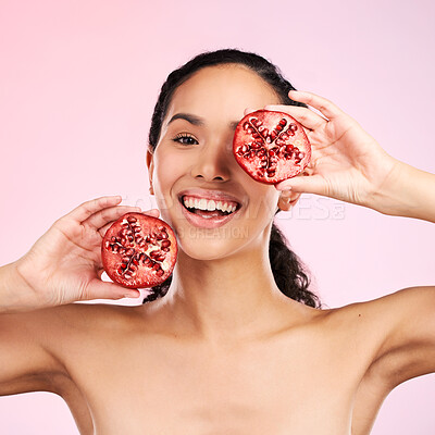 Buy stock photo Woman, skincare portrait and pomegranate for beauty, natural cosmetics and facial product or vitamin c benefits. Face of person, red fruits and eye dermatology or skin care on pink, studio background