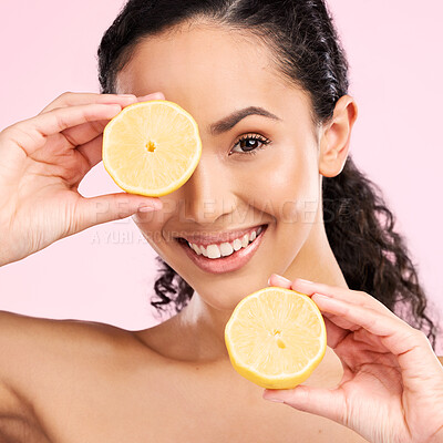 Buy stock photo Woman face, skincare portrait and lemon for beauty, cosmetics and natural product or vitamin c benefits. Happy, young person or model with fruits for eye dermatology on a pink, studio background