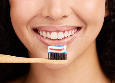 Buy stock photo Smile, wood toothbrush and studio closeup for dental wellness, woman and healthy mouth by pink background. Girl, model and natural toothpaste for teeth whitening, results and sustainable product