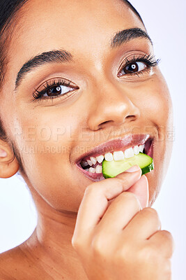 Buy stock photo Portrait, cucumber and Indian woman in studio for health, diet and detox, nutrition or wellness. Fruit, slice and face of lady with natural, vegan or organic snack for weight loss, fiber or hydration