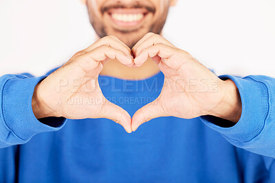 Buy stock photo Closeup, heart and hands of man in studio, white background and care for kindness, donation and charity. Happy model with finger shape for love icon, thank you and emoji in support of valentines day