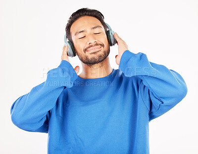 Buy stock photo Asian man, headphones and music in studio, white background and relax while hearing podcast subscription. Happy male model listening to calm audio, streaming sound and radio media with technology 