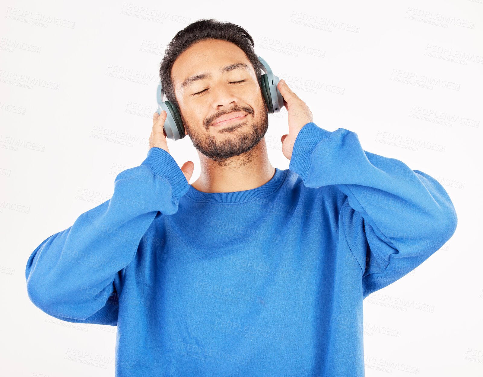 Buy stock photo Asian man, headphones and music in studio, white background and relax while hearing podcast subscription. Happy male model listening to calm audio, streaming sound and radio media with technology 